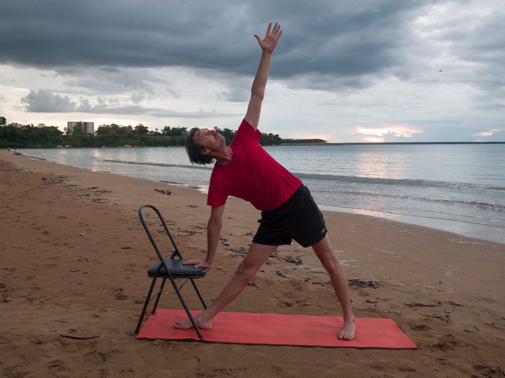 Stuart in triangle pose with a chair