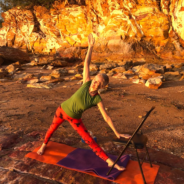 Yoga for arthritis: Triangle Pose with the lower hand on a chair, Top End beach