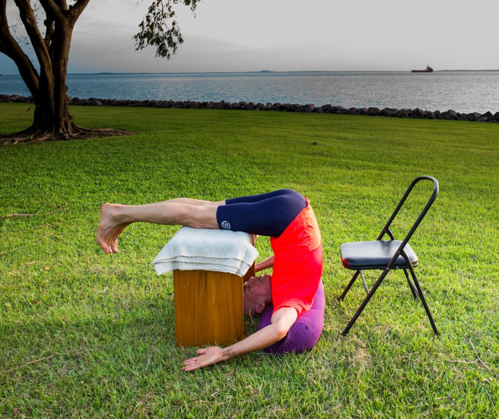 Stuart in a supported inversion with the legs over a stool