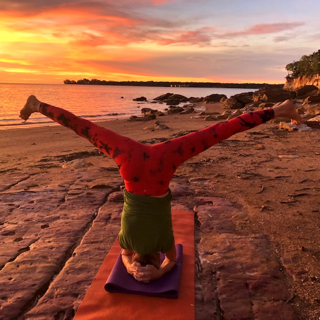 Longer holds in Iyengar yoga: Chris Lalor in a wide angle headstand variation at sunset