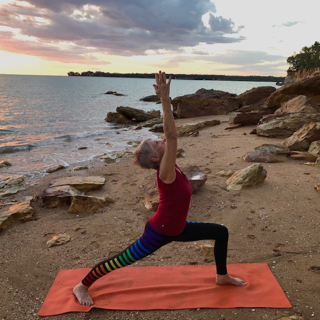 Yoga poses for diabetes: Chris Lalor in Warrior 1 on a Darwin beach