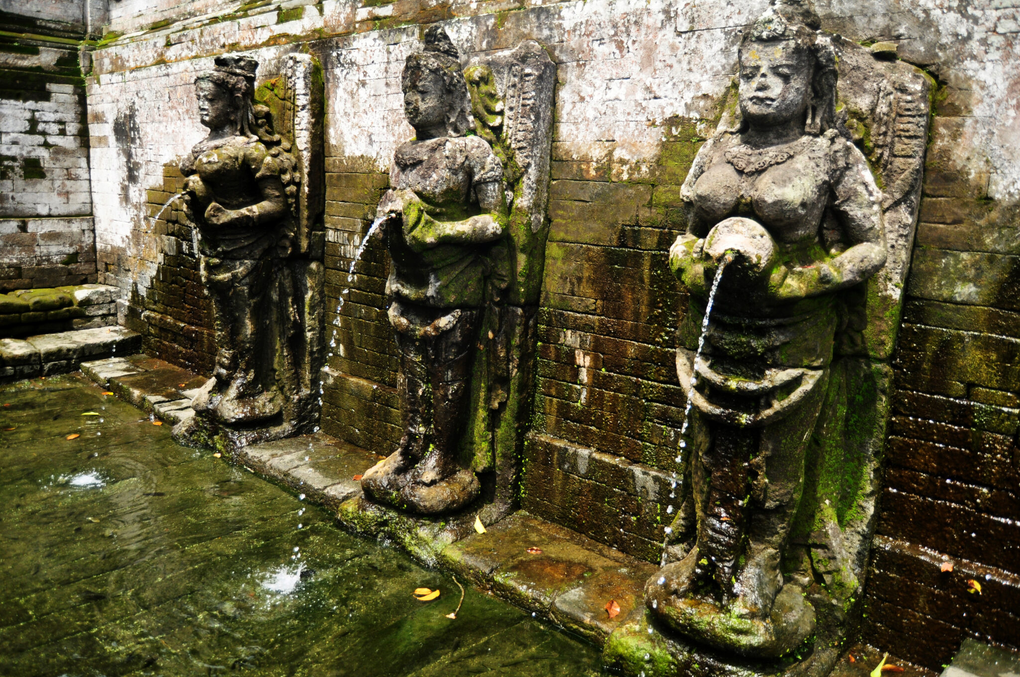 Carved stone figures pouring water into the bathing pools at Goa Gajah, the elephant cave, near Ubud in Bali