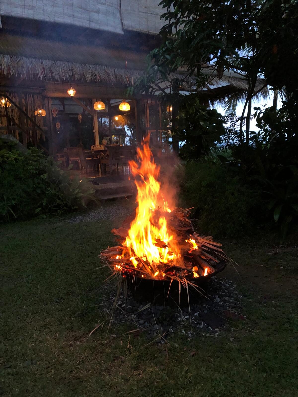 A bonfire on the beach at night during a Flametree yoga retreat in Candidasa, Bali