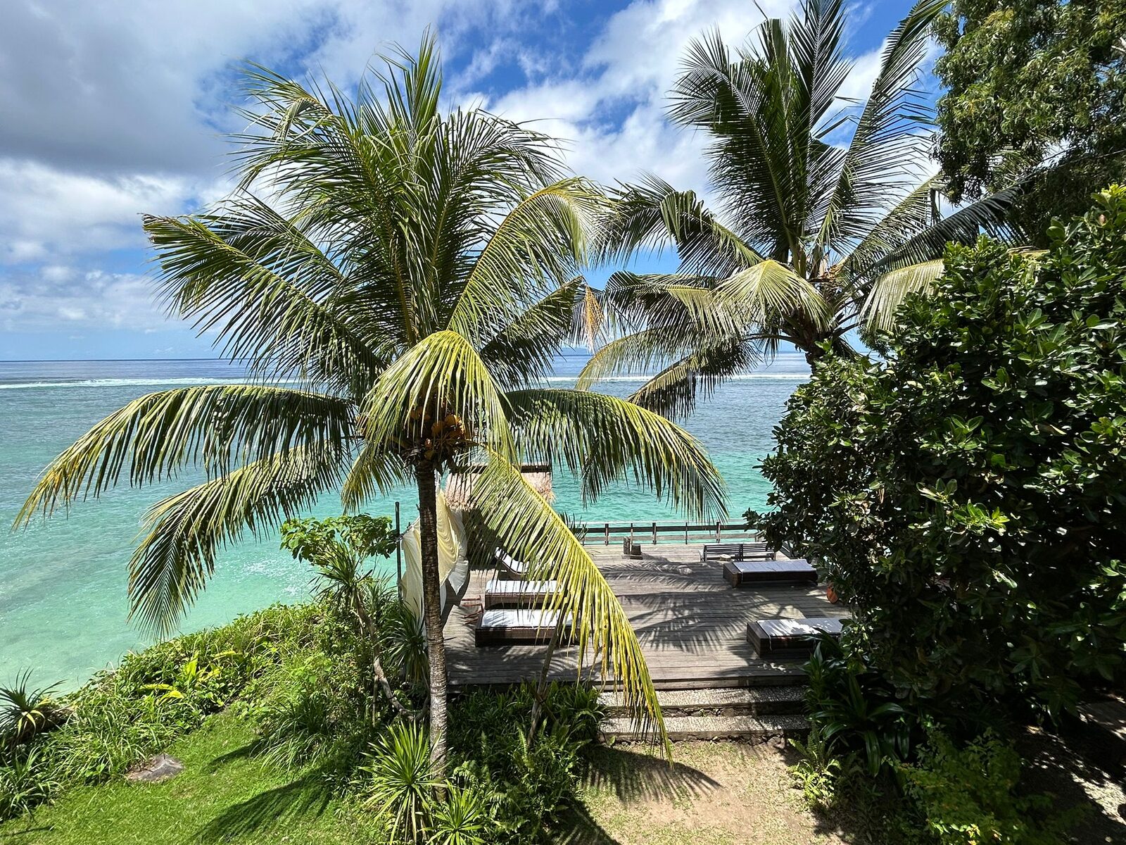 Palm trees and clear turquoise water at Candidasa on the east coast of Bali
