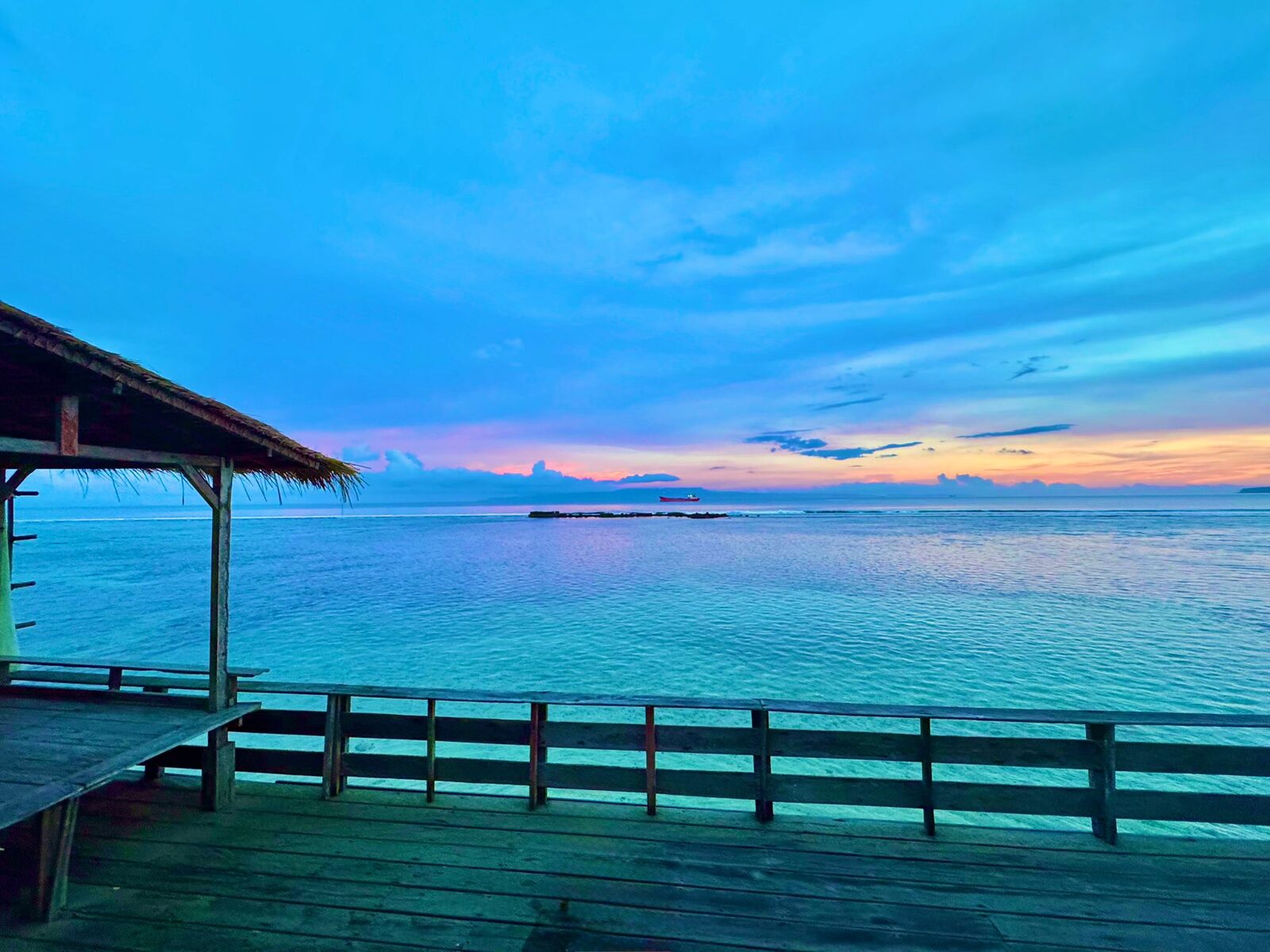 Sunset over the sea from the jetty at Pondok Pisang, Candidasa, East Bali
