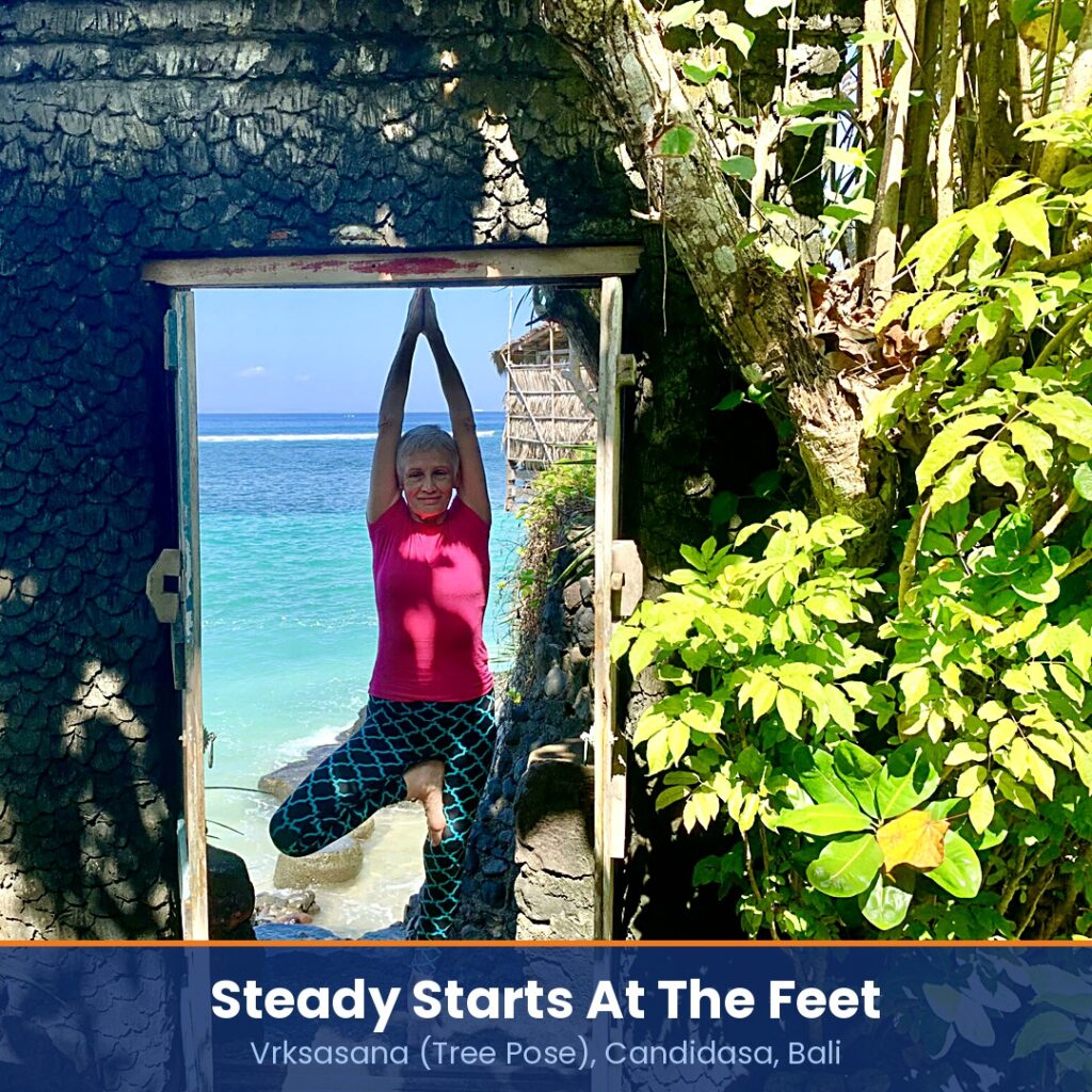 Chris Lalor in Vrksasana, Tree Pose, in a stone doorway above the sea at Candidasa, Bali, captioned steady starts at the feet