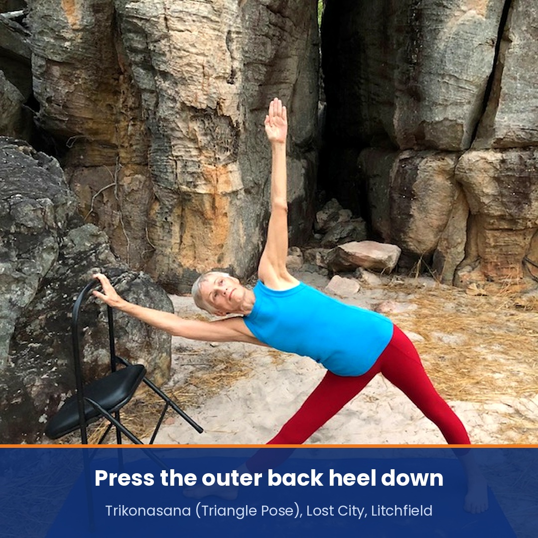 Yoga poses for back pain: Chris Lalor in Triangle Pose with a chair