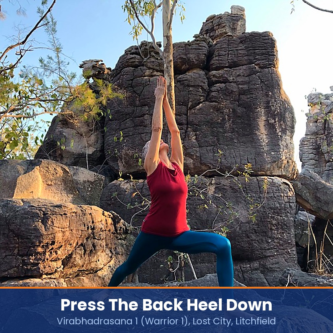 Psoas stretch: Chris Lalor in Warrior 1 among rock towers, captioned press the back heel down