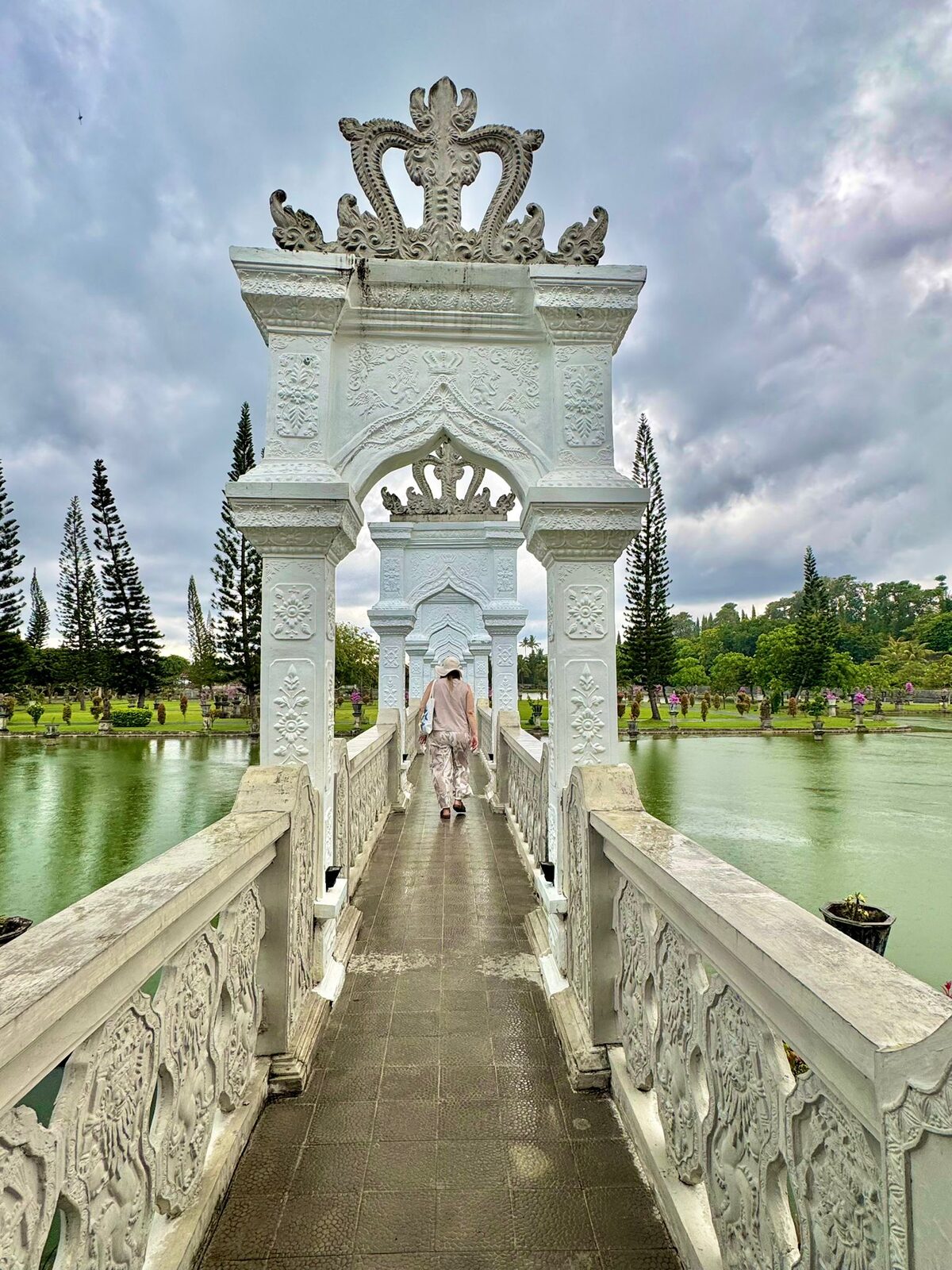 The white carved gateway on the causeway leading to the Bale Gili pavilion at Taman Ujung, Bali