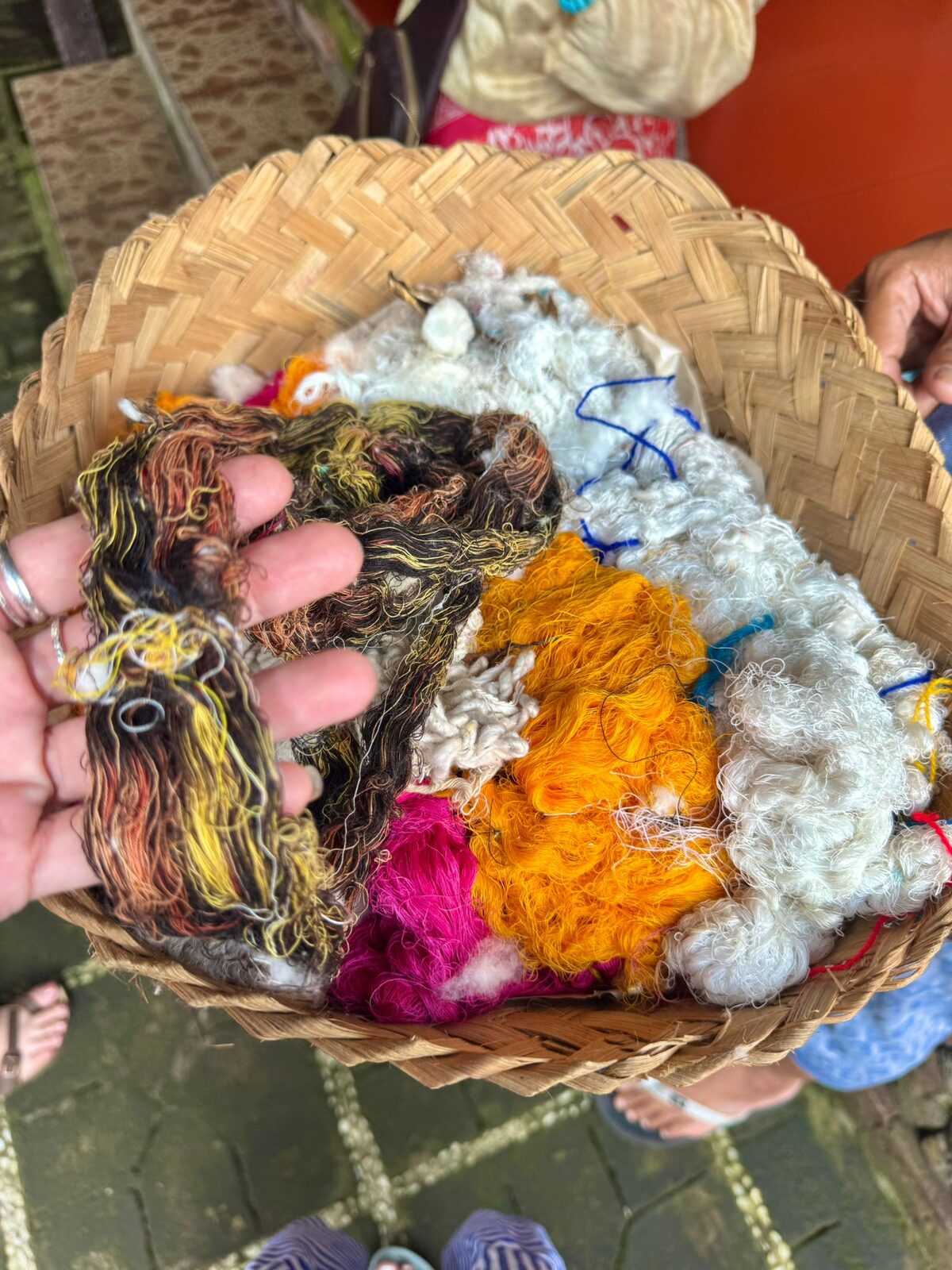 A basket of hand dyed yarn in orange, pink and cream used for geringsing weaving in Tenganan, Bali