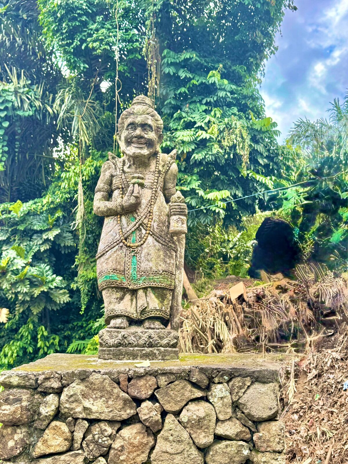 A carved stone guardian figure at the entrance to Tenganan village, East Bali