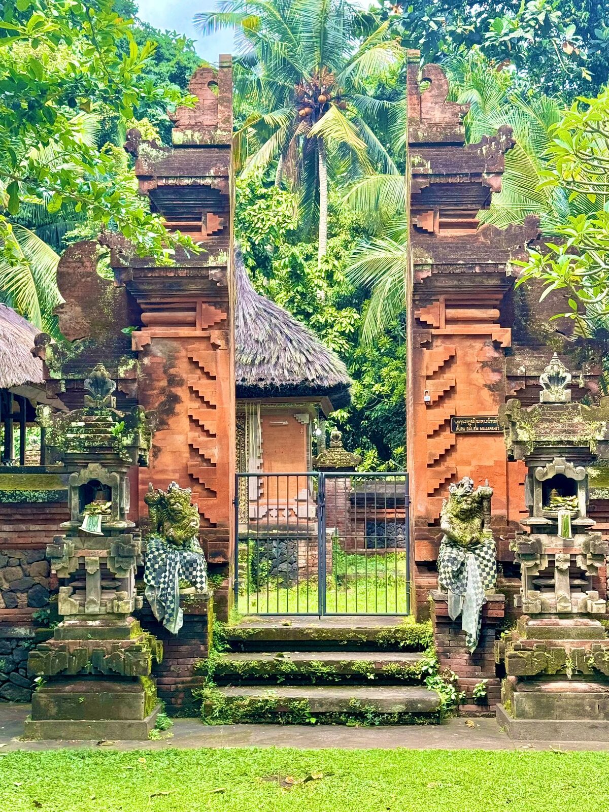 A red brick split gateway into a family compound in Tenganan Pegringsingan village, East Bali