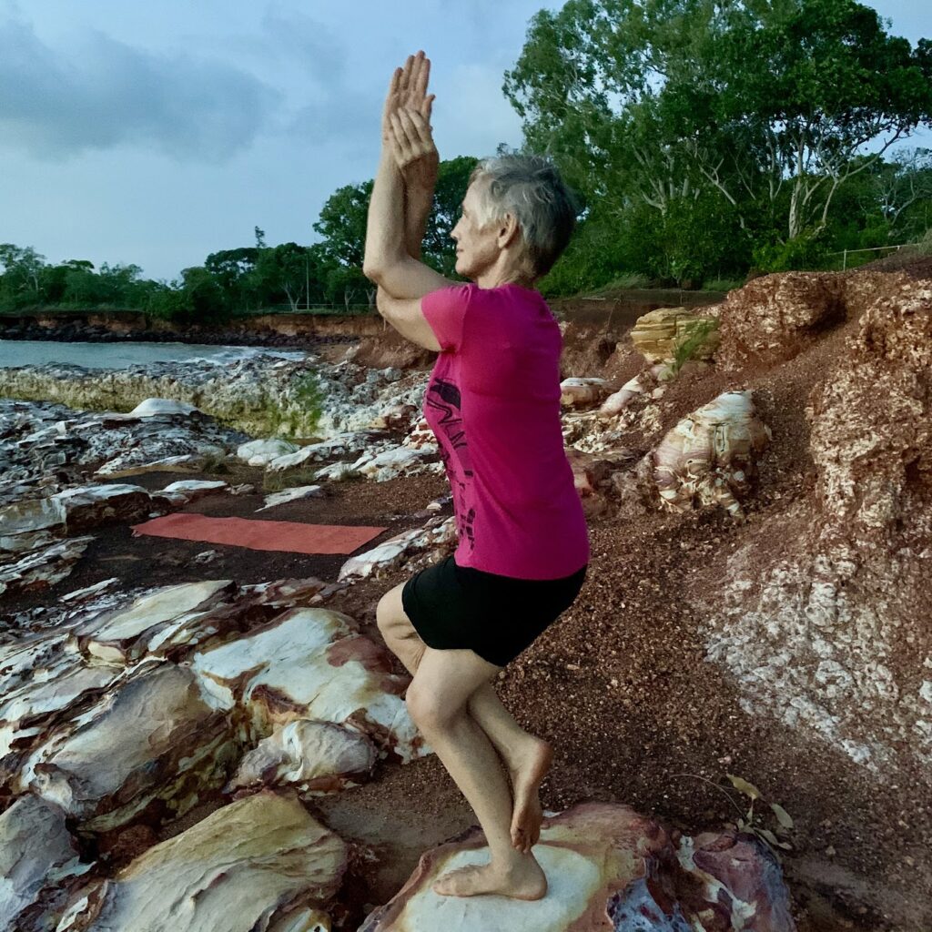 Eagle pose (Garudasana) by Chris Lalor on the rocks at East Point, Darwin