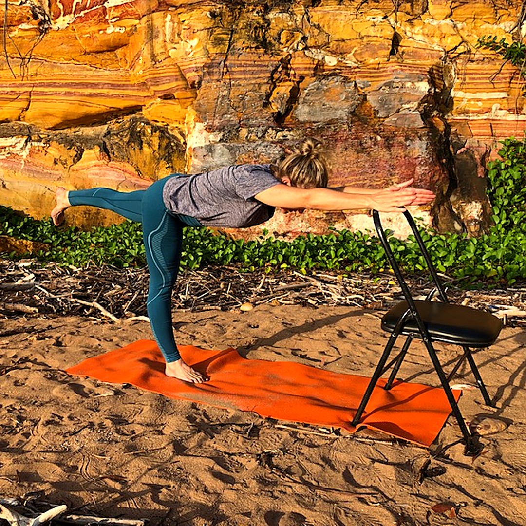 Ankle strengthening exercises: Kim standing on one leg in Warrior III with her hands on a chair
