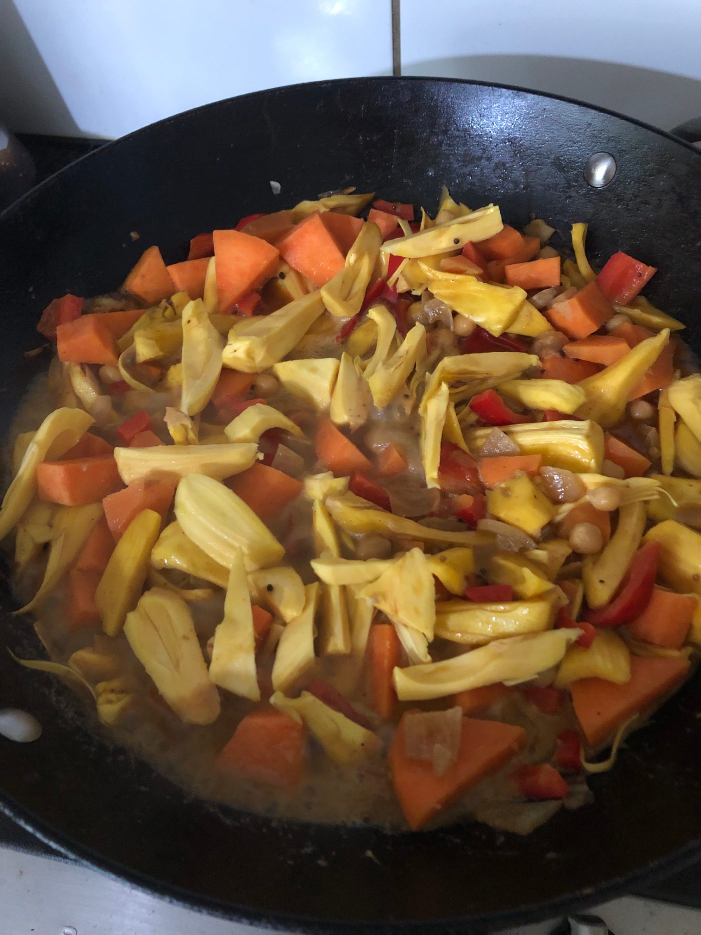 Jackfruit, sweet potato and red capsicum simmering in coconut milk