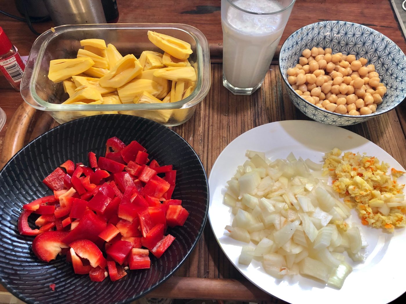 Fresh jackfruit, chickpeas, coconut milk, red capsicum and onion ready for a jackfruit curry
