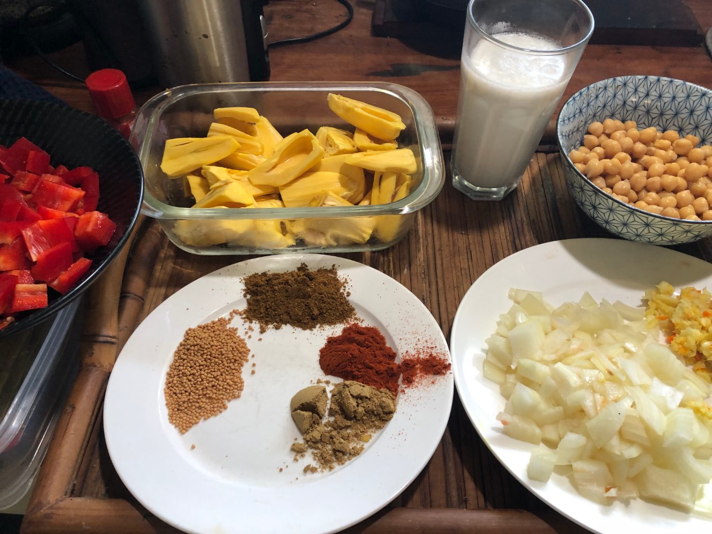 Ground spices measured out on a plate for a jackfruit curry