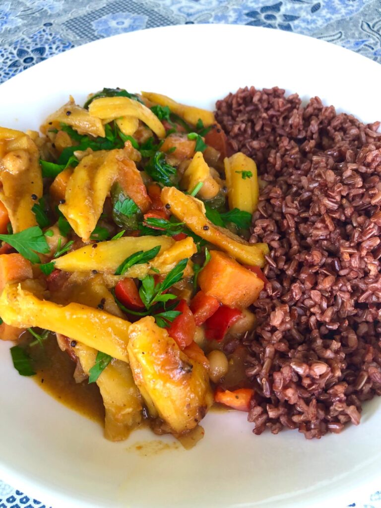Vegan jackfruit curry with sweet potato and chickpeas, served with red rice