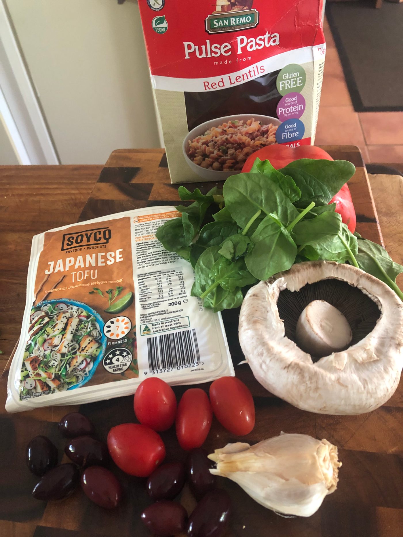 Lentil pasta with Japanese style tofu, baby spinach, a mushroom and baby tomatoes
