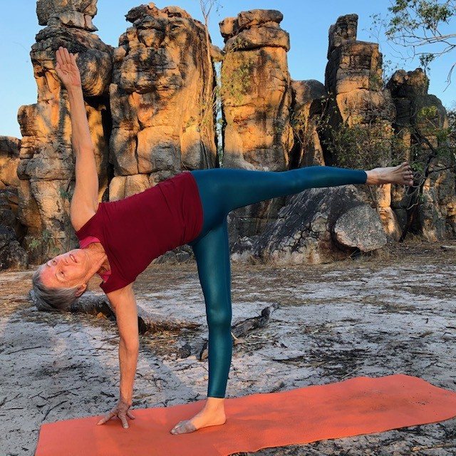 Osteopenia exercises that load bone: Chris Lalor in Half Moon Pose among the rock towers of the Lost City, Litchfield, standing leg straight