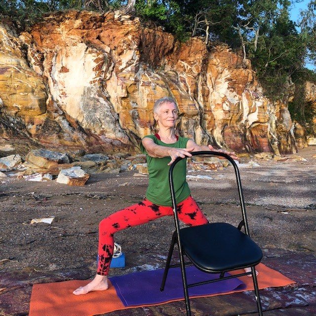 A Tree Pose variation with a chair close by, building balance and loading the standing leg and hip