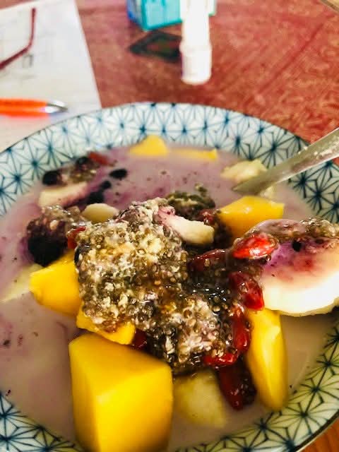 Overnight chia and quinoa breakfast in a patterned bowl, topped with red goji berries and fruit
