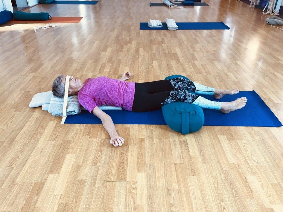 Pranayama Darwin: students lying supported on bolsters and blankets at the start of a Flametree pranayama class