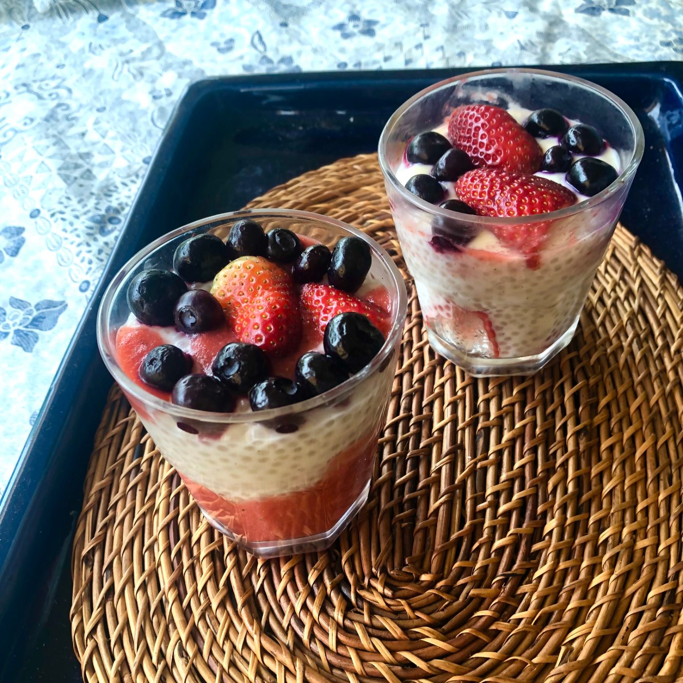 Glasses of tapioca pudding showing the strawberry layer through the glass